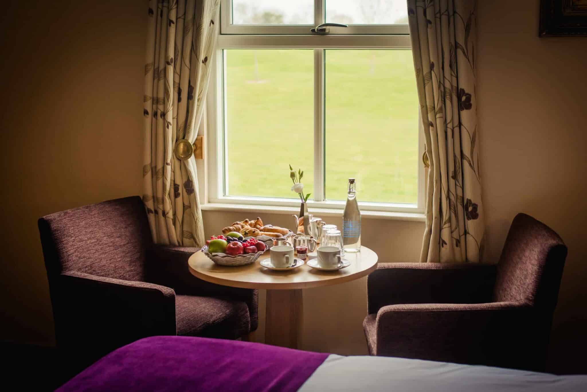 Roganstown Hotel Country Club Swords view of room with chairs and pastries and fruit on table